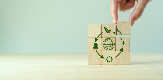 Circular economy concept, recycle, environment, reuse, manufacturing, waste, consumer, resources. LCA Life cycle assessment. Sustainability Wooden cubes; symbol of circular economy on grey background.