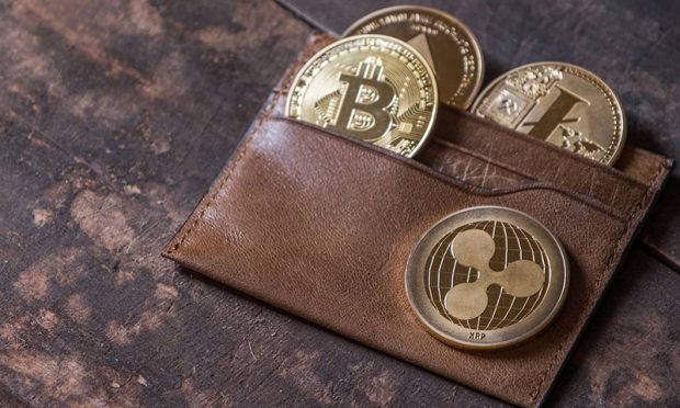 Popular cryptocurrency in leather wallet on wooden table top