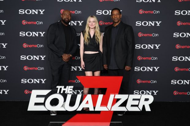 LAS VEGAS, NV - APRIL 24, 2023: Antoine Fuqua, Dakota Fanning and Denzel Washington at the CinemaCon Photo Call for Sony Pictures THE EQUALIZER 3 at The Colosseum at Caesar's Palace.