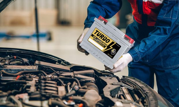 Male mechanic changing car battery, engineer is replacing car battery because car battery is depleted. concept car maintenance