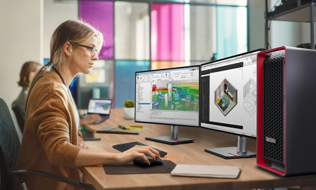 Yeni Lenovo ThinkStation - Caucasian Woman Coding on Desktop PC and Laptop Setup With Multiple Displays in Spacious Office. Female Junior Software Engineer Working on New Sprint of Mobile Application Development For Start-up.