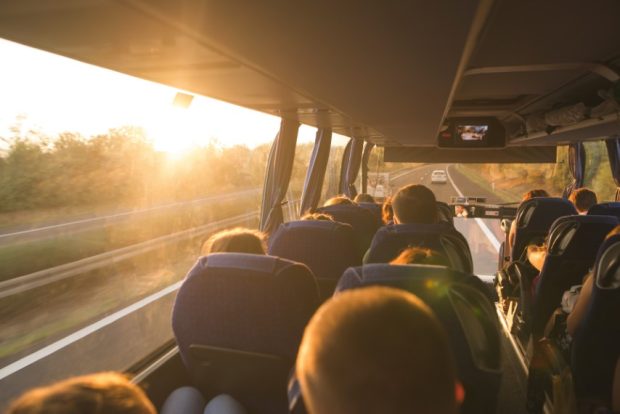 Online seyahat biletleme, araç kiralama ve otel rezervasyonu platformu Obilet, “2023 Yılı Seyahat İstatistiklerini” açıkladı. Background. Bus interior. Salon of the bus with people fill the sun with light in the sunset. People travel on a big tourist bus. The bus rides along the mornings in the sunrise